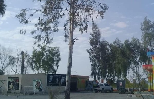 Posters of IRGC Quds Force commander Qassem Soleimani and Syrian president Bashar al-Assad are plastered on a wall at an IRGC gas station at the entrance to the town of Mahkan, a Sayyida Zainab Brigade stronghold. [Naher Media]