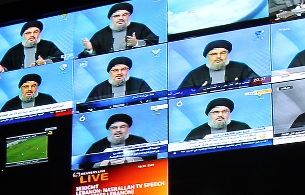 Hizbullah chief Hassan Nasrallah is seen on broadcast screens at Hizbullah-owned al-Manar TV in Beirut in this file photo from January 16, 2010. [Anwar Amro/AFP]