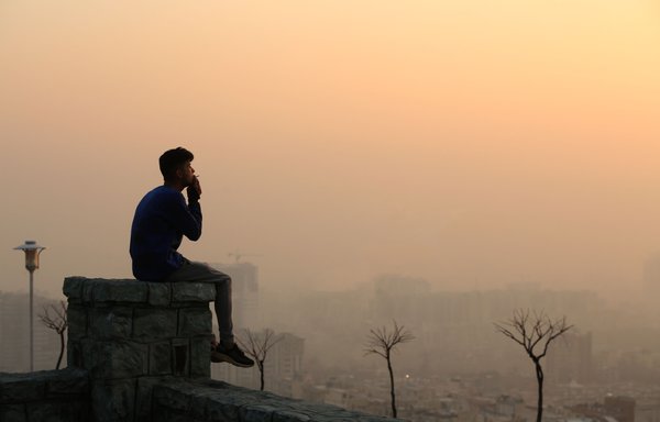 Smog obscures the view from the Saad Abad mountain north of the Iranian capital Tehran with high levels of air pollution, on January 13. [Atta Kenare/AFP]