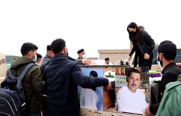 Yazidi activist Nadia Murad says a final farewell to two of her brothers, killed by ISIS, during a February 6 mass funeral in the Sinjar district of Kojo in northern Iraq. [Nadia Murad/Twitter]