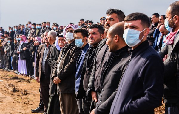 People attend a mass funeral for Yazidi victims of ISIS in the northern Iraqi village of Kojo in Sinjar district, on February 6, 2021. [Zaid AL-OBEIDI / AFP]