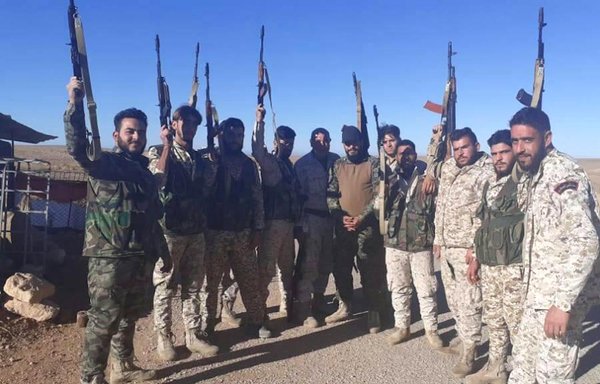 Members of the Russia-backed Sanad company pose with weapons in Syria in an undated photo. [Sanad]