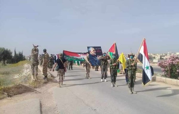 Members of an IRGC-aligned militia in Syria carry a photo of the late IRGC Quds Force commander, Qassem Soleimani, in an undated photo. [Syrian Observatory for Human Rights]