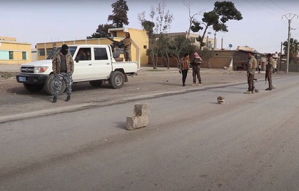 Members of the SDF check identifications at a security checkpoint in rural Deir Ezzor as part of their mission to identify ISIS elements and their collaborators. [SDF]