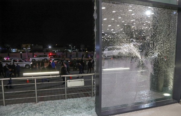 Shattered glass is pictured on the floor of a shop following a rocket attack in the city of Erbil in northern Iraq's Kurdish region, on February 15. [Safin Hamed/AFP]