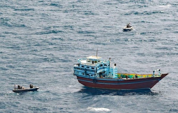 Teams from guided-missile destroyer USS Winston S. Churchill prepare to board a stateless dhow off the Somali coast on February 12. An illicit shipment of weapons and weapon components was found onboard. [US Navy]