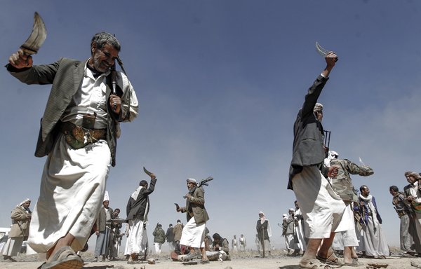 In this file photo taken November 1, 2016, Houthis take part in a gathering to mobilise more fighters on the outskirts of Sanaa. [Mohammed Huwais/AFP]