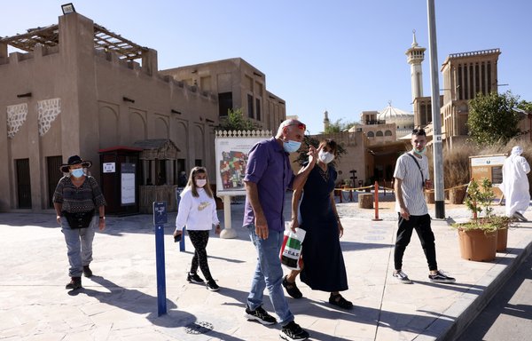 Israeli tourists, mask-clad due to the coronavirus pandemic, visit al-Fahidi Historical Neighbourhood of Dubai on January 11. [Karim Sahib/AFP]