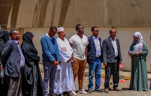Members representing African communities in Yemen gather to speak in front of the offices of the International Organisation for Migration in Sanaa on March 13, following a March 7 fire in a holding facility. Human Rights Watch says 'unidentified projectiles' launched by the Houthis caused the blaze. [Mohammed Huwais/AFP]