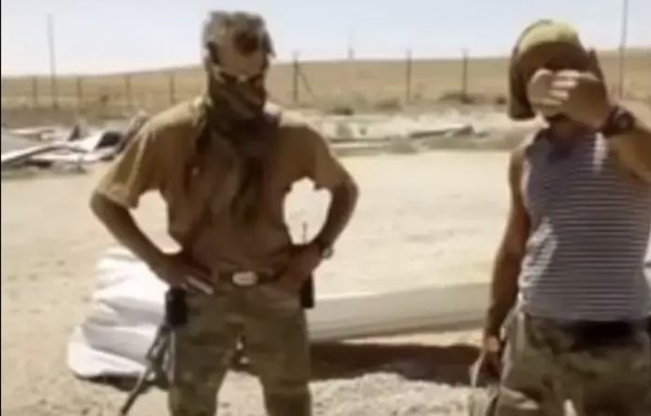Two members of the Wagner Group who tortured, killed and mutilated a Syrian man in 2017 are seen here in a screenshot from a video circulated online. [File]