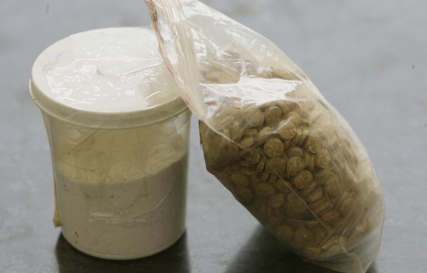 Captagon pills are displayed along with a cup of cocaine at an office of the Lebanese Internal Security Forces, Anti-Narcotics Division in Beirut in this file photo from June 11, 2010. [Joseph Eid/AFP]