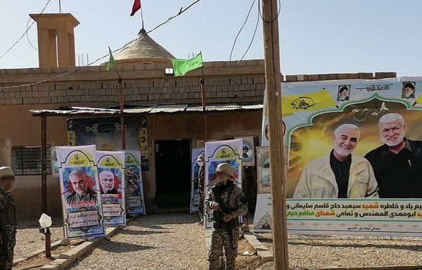 An element of the Fatemiyoun Division stands outside a religious centre in Deir Ezzor during the commemoration of IRGC Quds Force commander Qassem Soleimani's death. [Fatemiyoun/Telegram]