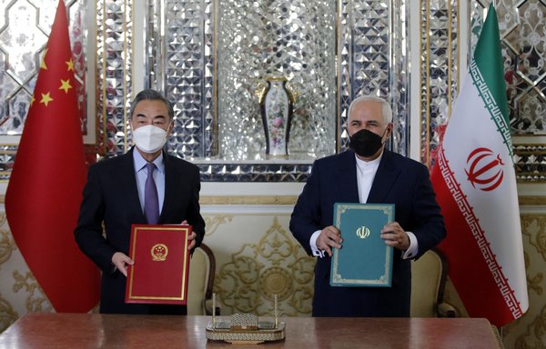 Chinese Foreign Minister Wang Yi and his Iranian counterpart Javad Zarif pose for a picture after signing a '25-year strategic co-operation pact' in Tehran on March 27. [AFP]