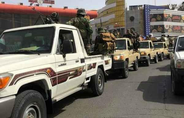 Elements of the Iran-linked Rubu Allah group stage an armed parade in the streets of Baghdad on March 25. [Huna al-Basra/Facebook]