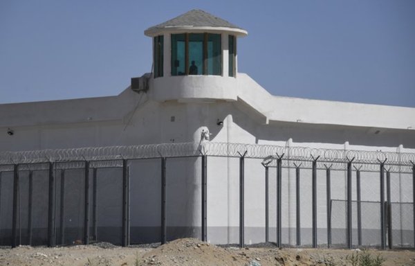 The reality: a watchtower on a high-security facility near one of the many 're-education camps' in Xinjiang. [Greg Baker/AFP]