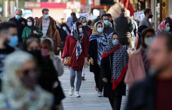 Iranians wearing face masks in Tehran on March 29 as COVID-19 infections rise across the country. [AFP]