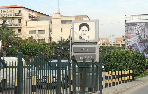 A street in Beirut's Hizbullah stronghold near the airport is named after the founder of the Islamic Republic, Rouhollah Khomeini. Iran's funding for Hizbullah has faltered in recent years, contributing to the increasing hardships afflicting the party's base in Lebanon. [Ziad Hatem/Al-Mashareq]