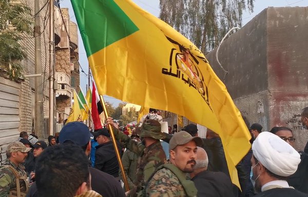 Elements of the Iran-backed Iraqi militia Kataib Hizbullah pay tribute to Ammar Abu Yasser al-Muallem, one of the militia's senior figures, who was killed February 20. [Screenshot from a video posted online by Kataib Hizbullah]