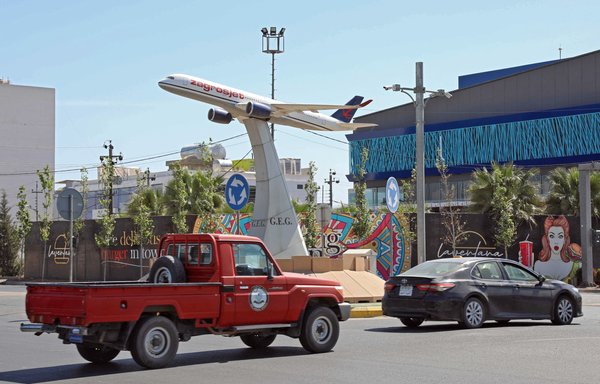 The model of an airplane decorates a square near Erbil's International Airport in the capital of Iraq's Kurdish region on April 15. An explosives-packed drone slammed into the airport late on April 14 in the first reported use of such a weapon against a base used by US-led coalition troops in the country. [Safin Hamed/AFP]