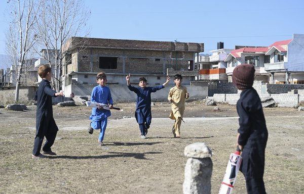 In this picture taken on February 11, children play cricket at the site of the demolished compound of slain former al-Qaeda leader Osama bin Laden in Abbottabad. The patch of scorched grass and scattered rubble in Abbottabad is all that remains of the final lair of the most wanted person on the planet. Bin Laden was killed by US Navy special forces there May 2, 2011. [Farooq Naeem/AFP]