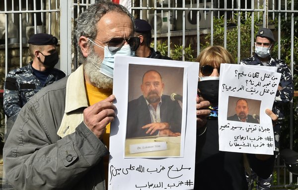 Anti-Hizbullah protesters February 4 in Beirut hold pictures of slain Lebanese activist Lokman Slim. [STR/AFP]