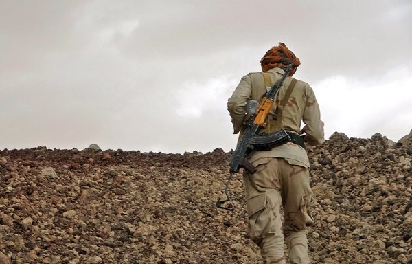 A fighter loyal to Yemen's government mans a position near the frontline facing the Iran-backed Houthis in the country's northeastern province of Marib on April 27. [AFP]