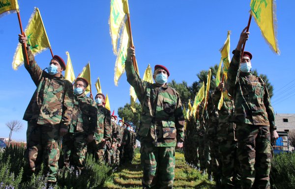 In this file photo taken on February 13, members of Hizbullah hold a military parade in the town of Riyaq in Lebanon's Bekaa Valley. [AFP]