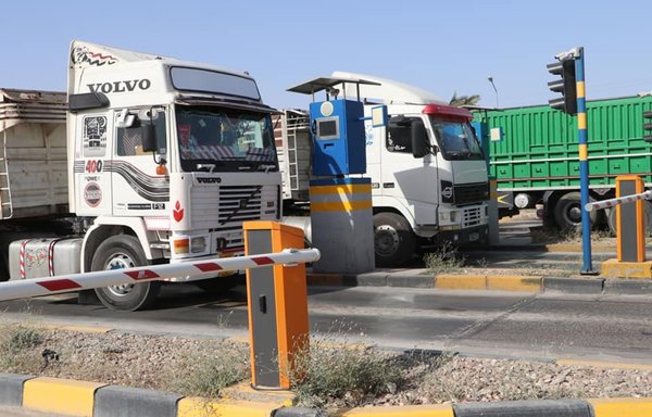Two trucks loaded with imported goods await departure from the Basra province port of Umm Qasr on February 29. [Umm Qasr port]