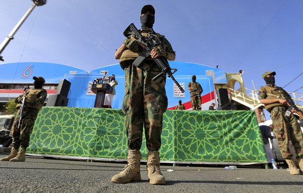 Security forces loyal to the Houthis stand guard during a March 26 rally in Sanaa, marking the sixth anniversary of the Arab Coalition's intervention on behalf of the legitimate government in Yemen. [Mohammed Huwais/AFP]