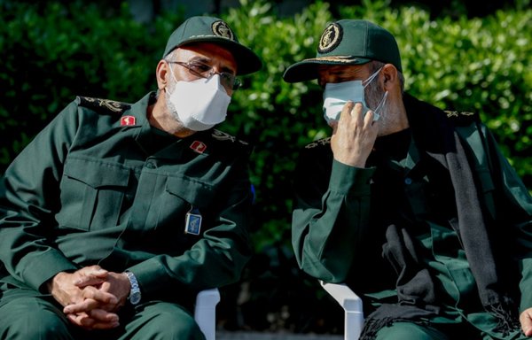 Two IRGC officers talk at an event in Tehran at the end of April. [Iranian Ministry of Defense]