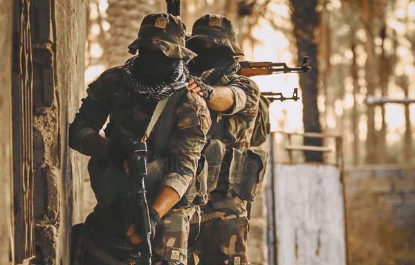 Members of Iran-backed Kataib Hizbullah strike a pose in a propaganda photo posted on the militia's website.