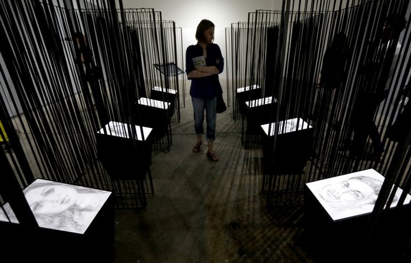 A picture taken in 2017 shows portraits drawn between 2014 and 2016 by Syrian artist Azza Abu Rebieh of her friends who were detained or abducted by the Syrian regime. Over 40,000 people are estimated to have died under torture in Syrian prisons during the war. [Anwar Amro/AFP]