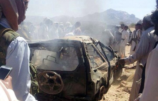 Yemenis gather around a car that was hit by an airstrike, killing three suspected al-Qaeda militants, as it travelled between Marib and Shabwa provinces, in this file photo from January 26, 2015. [AFP]