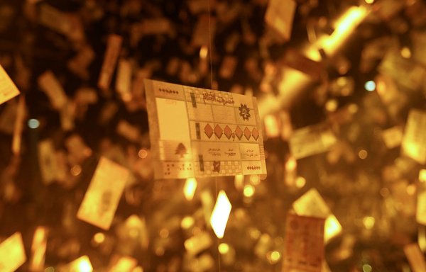 Mock Lebanese banknotes bearing only zero digits and reading "Bank of Dreams" are seen at an art installation titled 'Menhara' (collapsed) by Lebanese artist Carlo Kassabian reflecting on the currency devaluation, at a club in Beirut on May 8. [Anwar Amro/AFP]