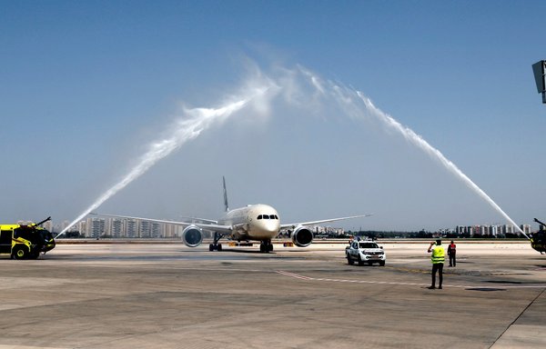 A water salute welcomes an Etihad Airways Boeing 787-9 "Dreamliner" aircraft after landing upon arrival from the United Arab Emirates at Israel's Ben Gurion Airport near Tel Aviv, on the company's first scheduled commercial flight from Abu Dhabi, on April 6, after the normalisation of ties between the two countries. [Jack Guez/AFP]