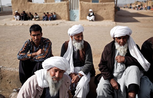Afghan men gather at the Shahid Nasseri refugee camp in Taraz Nahid village near the city of Saveh, some 130km southwest of Tehran, on February 8, 2015. Some 5,000 Afghan refugees live at the camp. [Behrouz Mehri/AFP]