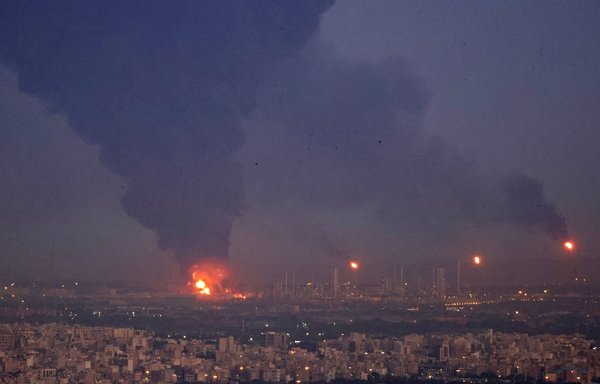 A picture taken June 2 shows smoke billowing from the site of a refinery fire in the Iranian capital Tehran. [Atta Kenare/AFP]