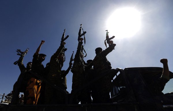 Houthi fighters chant slogans as they ride a military vehicle in the Yemeni capital Sanaa. [Mohammed HUWAIS / AFP]
