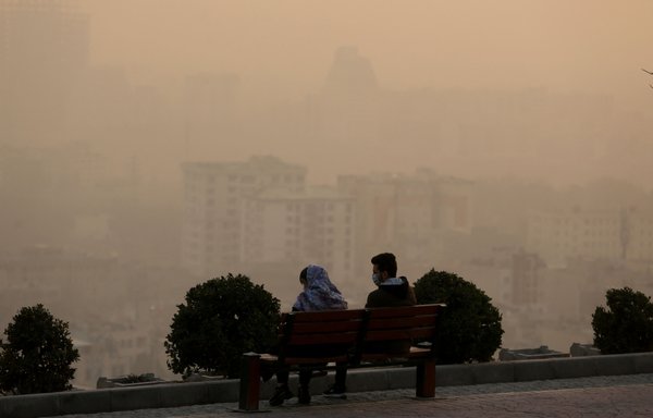 Smog obscures the view from the Saad Abad mountain north of the Iranian capital Tehran with high levels of air pollution, engulfing landmarks in the city, on January 13. [Atta Kenare/AFP]