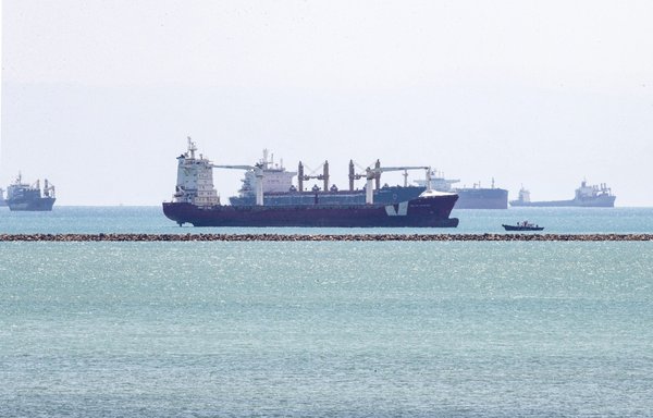 This picture taken March 28 shows the Gibraltar-flagged container ship Indian Express and the Panama-flagged container ship Elegant, behind it, near the entrance of the Suez Canal, by Egypt's Red Sea port city of Suez. [Ahmed Hasan/AFP]