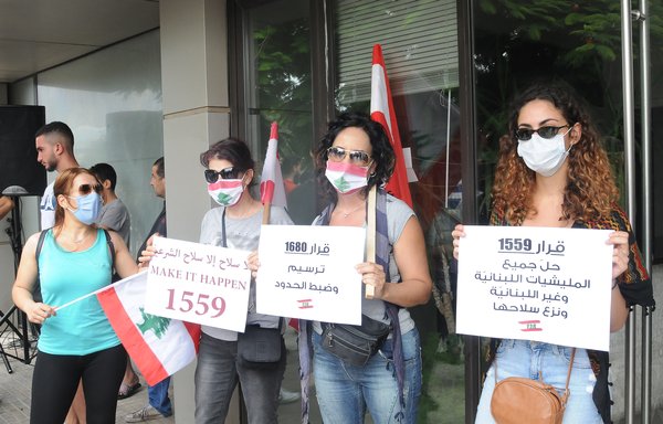 Lebanese women protesting outside the French embassy in Beirut on July 14 demand the full implementation of UN Security Council Resolution 1559, which calls for the disarmament of all militias in Lebanon, and decry Iran's interference in their country. [Ziad Hatem/Al-Mashareq]