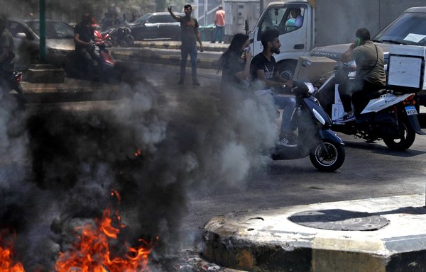 Lebanese demonstrators on June 17 block streets in Beirut with burning tires to protest against the deteriorating economic situation that many blame on Hizballah. [JOSEPH EID / AFP]