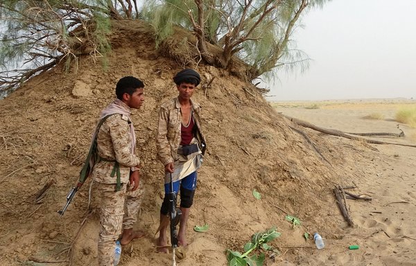 Pro-government fighters man a position near the frontline facing the Houthis in Yemen's Marib province on June 19. [AFP]