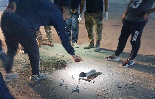 Iraqis inspect the remains of a projectile that was fired by groups loyal to Iran at Baghdad airport on April 22. [Photo circulated online]