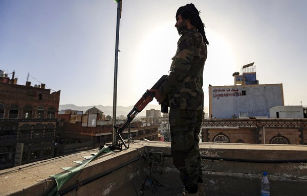 A Yemeni fighter aligned with the Iran-backed Houthis stands guard in Sanaa on January 25. The Houthis have carried out a series of attacks on Saudi oil installations in recent years. [Mohammed Huwais/AFP]