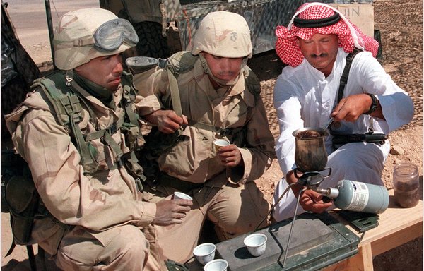 A Jordanian Bedouin serves coffee to two US Marines during a break from a military drill at Qatrana in this file photo from June 1998. Jordan has a long history of military ties with the United States. [AFP]