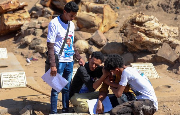 Mourners react during the January 2 funeral in Taez of TV reporter Adib al-Janani, who was killed in a December 30 attack on Aden airport that claimed at least 26 lives and has been blamed on the Iran-backed Houthis. [Ahmad al-Basha/AFP]