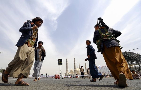 Fighters loyal to Yemen's Houthis stand guard in Sanaa on September 24 as the Houthis collect cash, food and other donations for their fighters. [Mohammed Huwais/AFP]