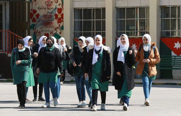 Jordanian pupils return to school for the first time in nearly a year, in the capital Amman, on February 7, as educational institutions gradually reopen after a governmental directive to ease COVID-19 restrictions. [Khalil Mazraawi/AFP]