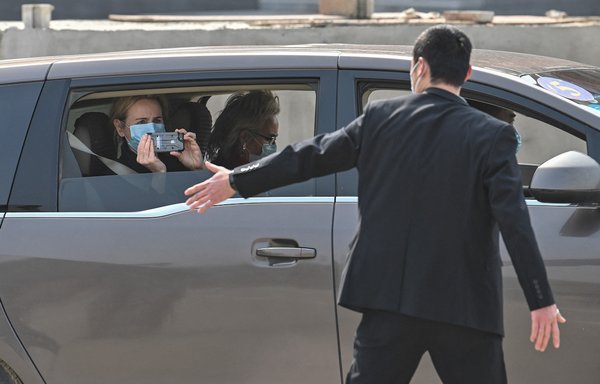 Members of the WHO team investigating the origins of the COVID-19 coronavirus leave the Wuhan Institute of Virology in Wuhan, Hubei province, China, on February 3. [Hector Retamal/AFP]